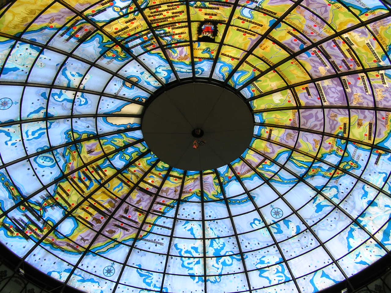 a round glass ceiling with various designs on it