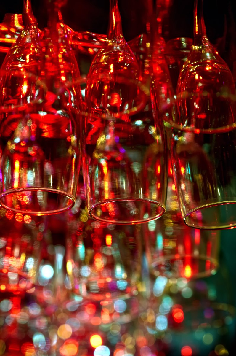 red wine glasses being held in a display