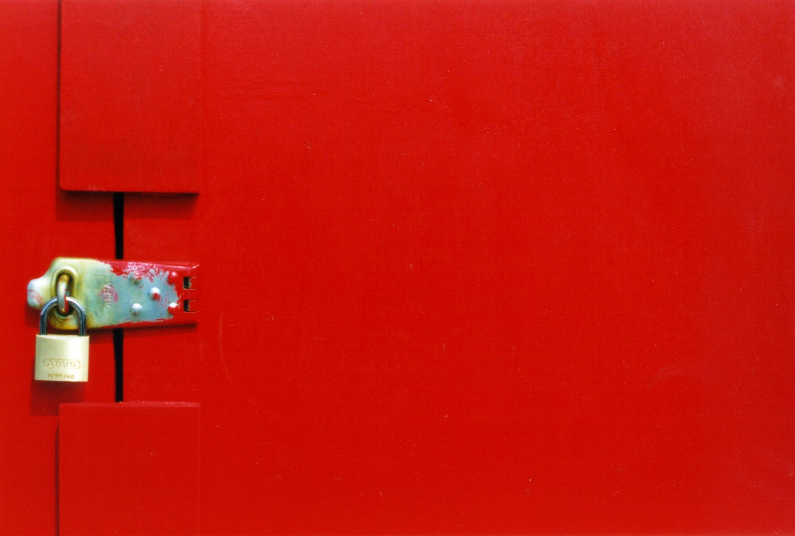 an orange painted door with a lock on it