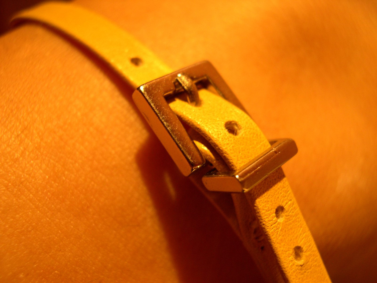 the strap has a tiny wooden square shaped buckle on it