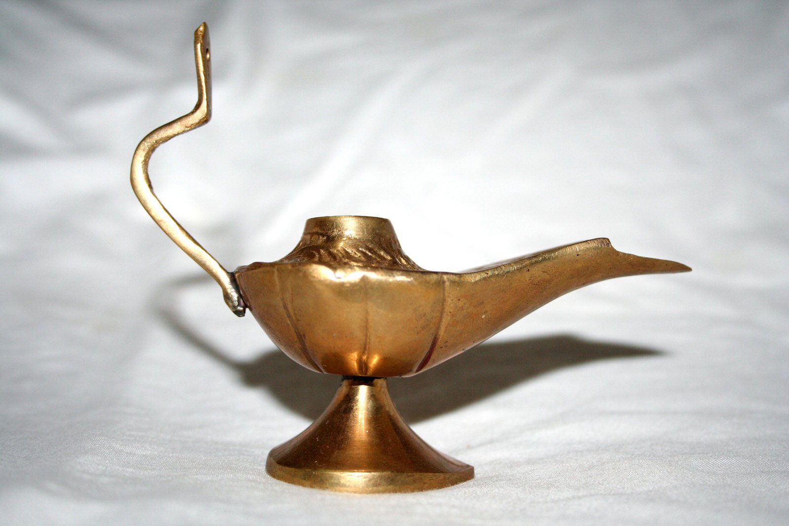 the gold bird has a long neck and curved stem