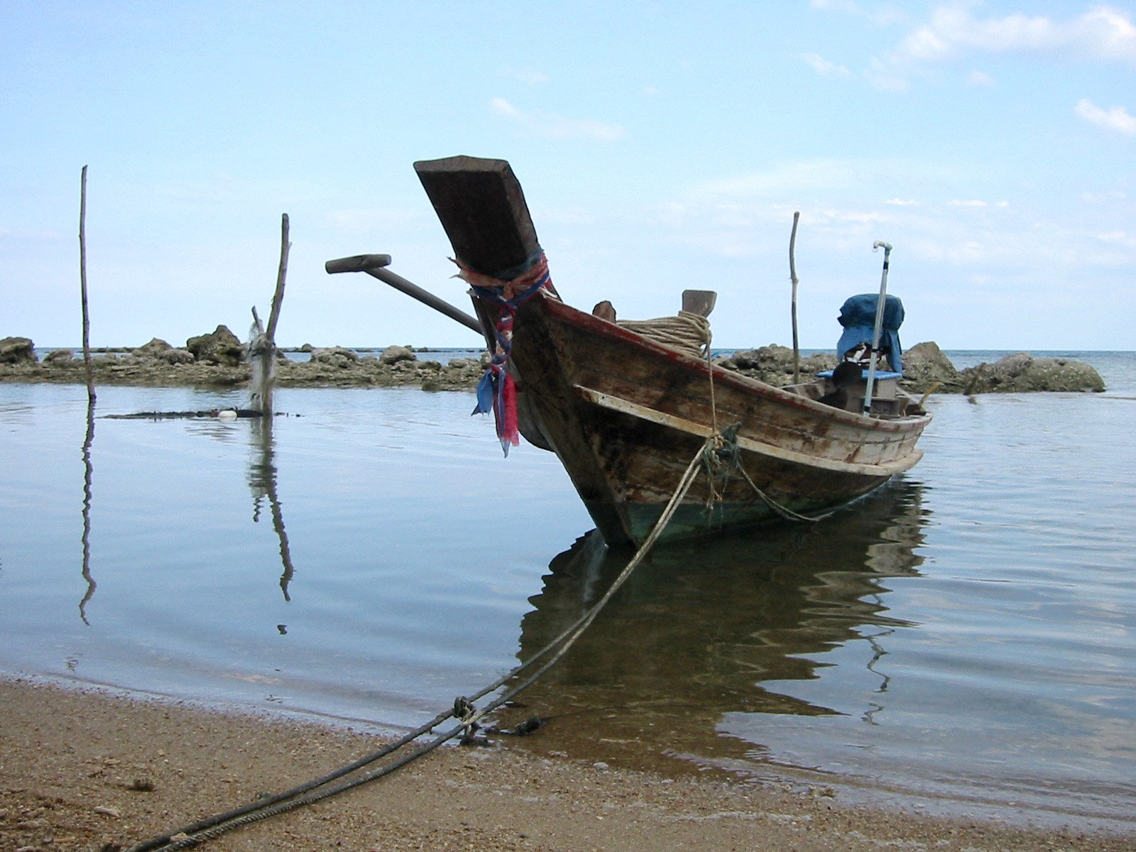 an old boat washed up in the sea water