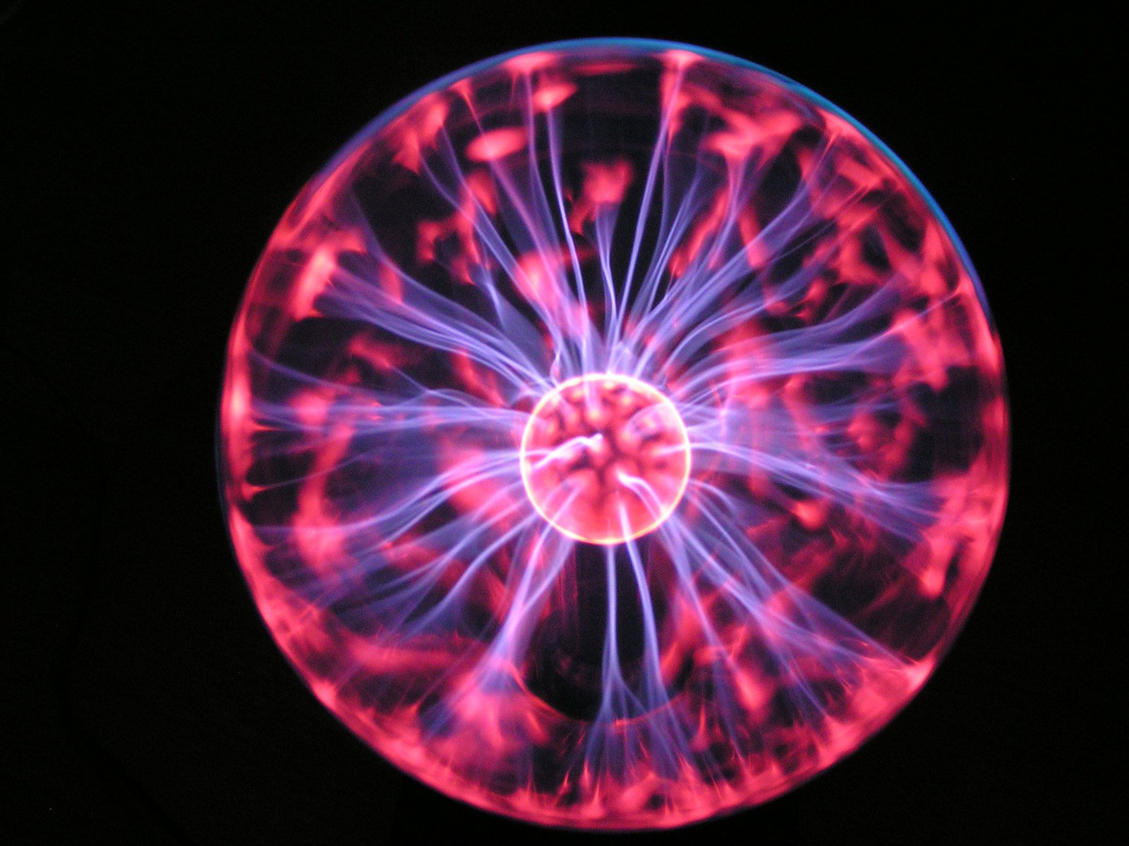a large circular object with purple and red swirling around it