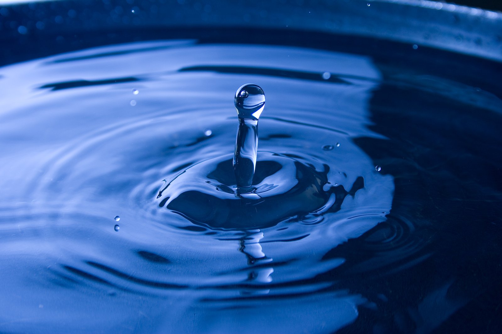 blue water ripples into a metal pot