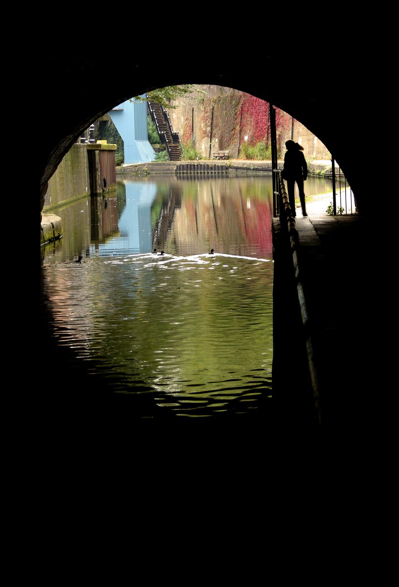 a person walking under a tunnel of water