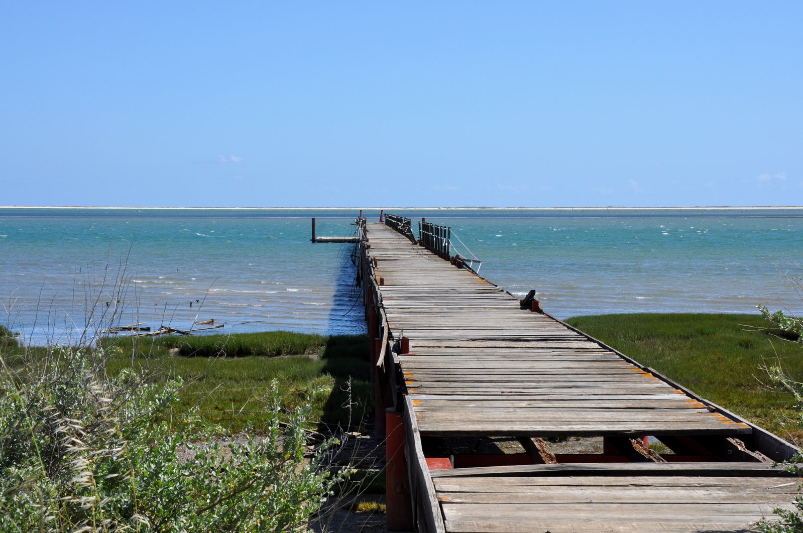 a boardwalk leading out to a beach