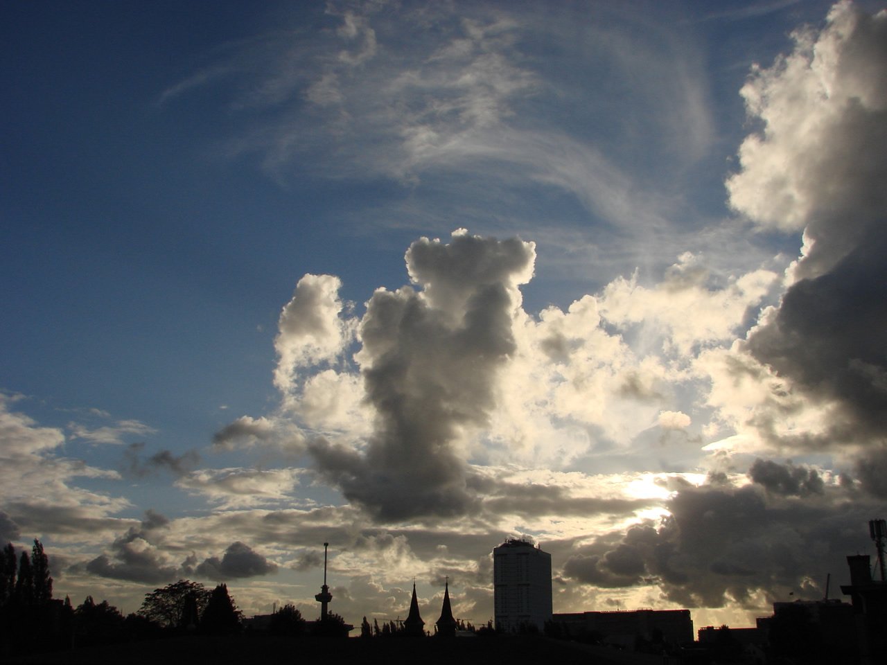 a group of large clouds in a blue sky