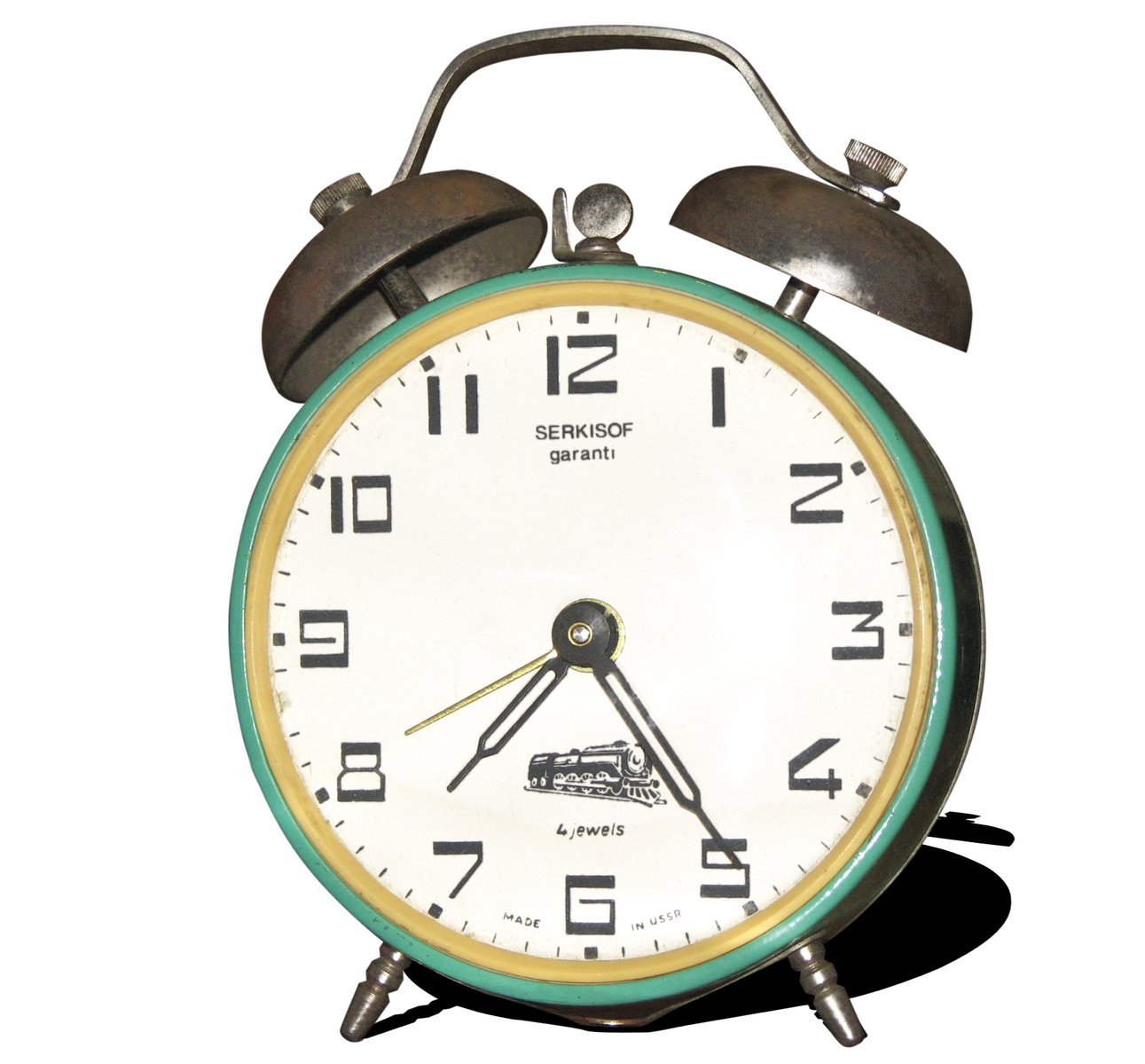 an antique style alarm clock, the time eleven o'clock