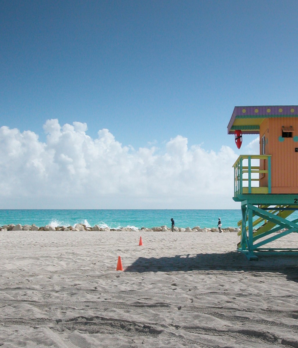 a lifeguard stand on the sand at the beach