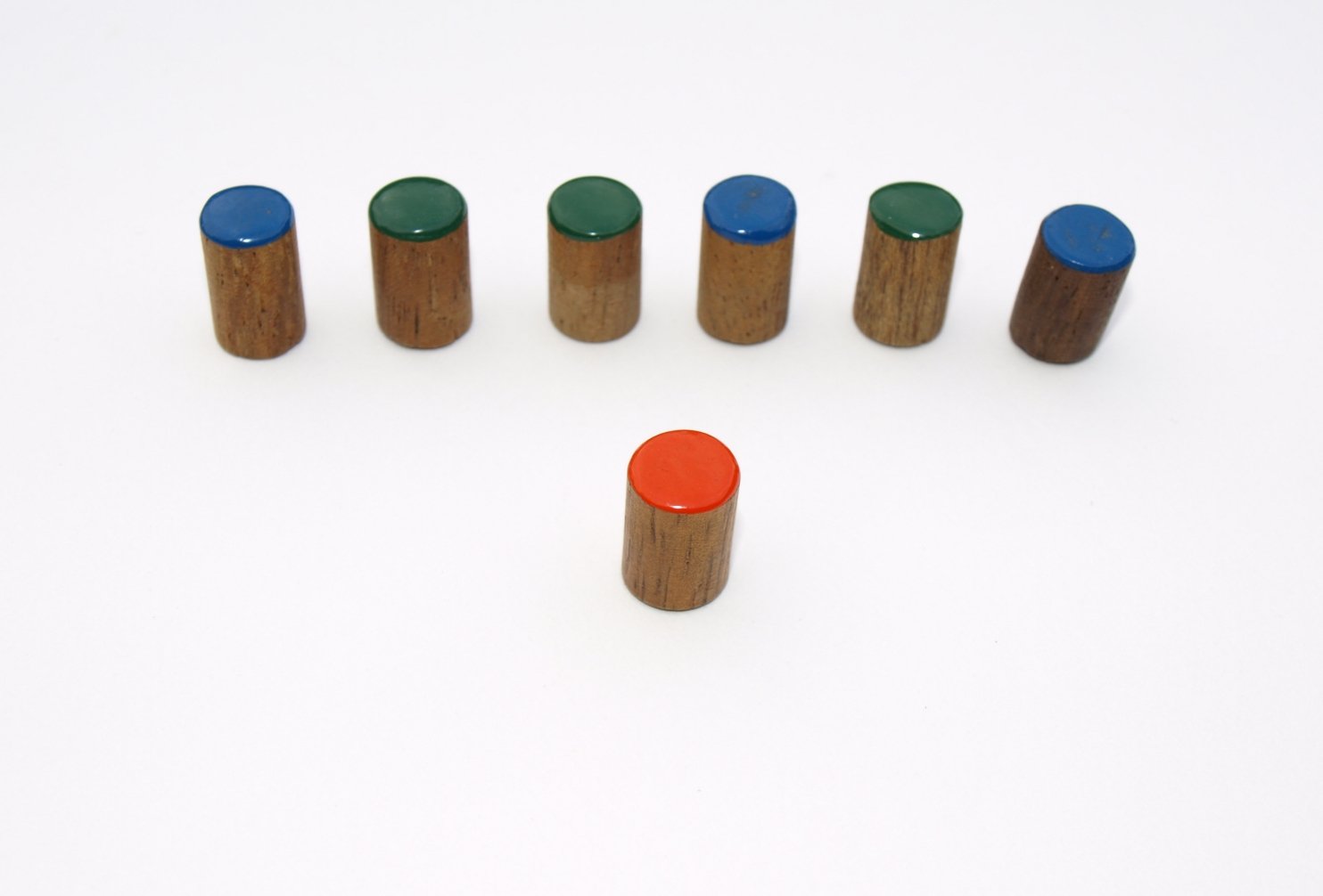 a group of small cylindrical containers containing different colors