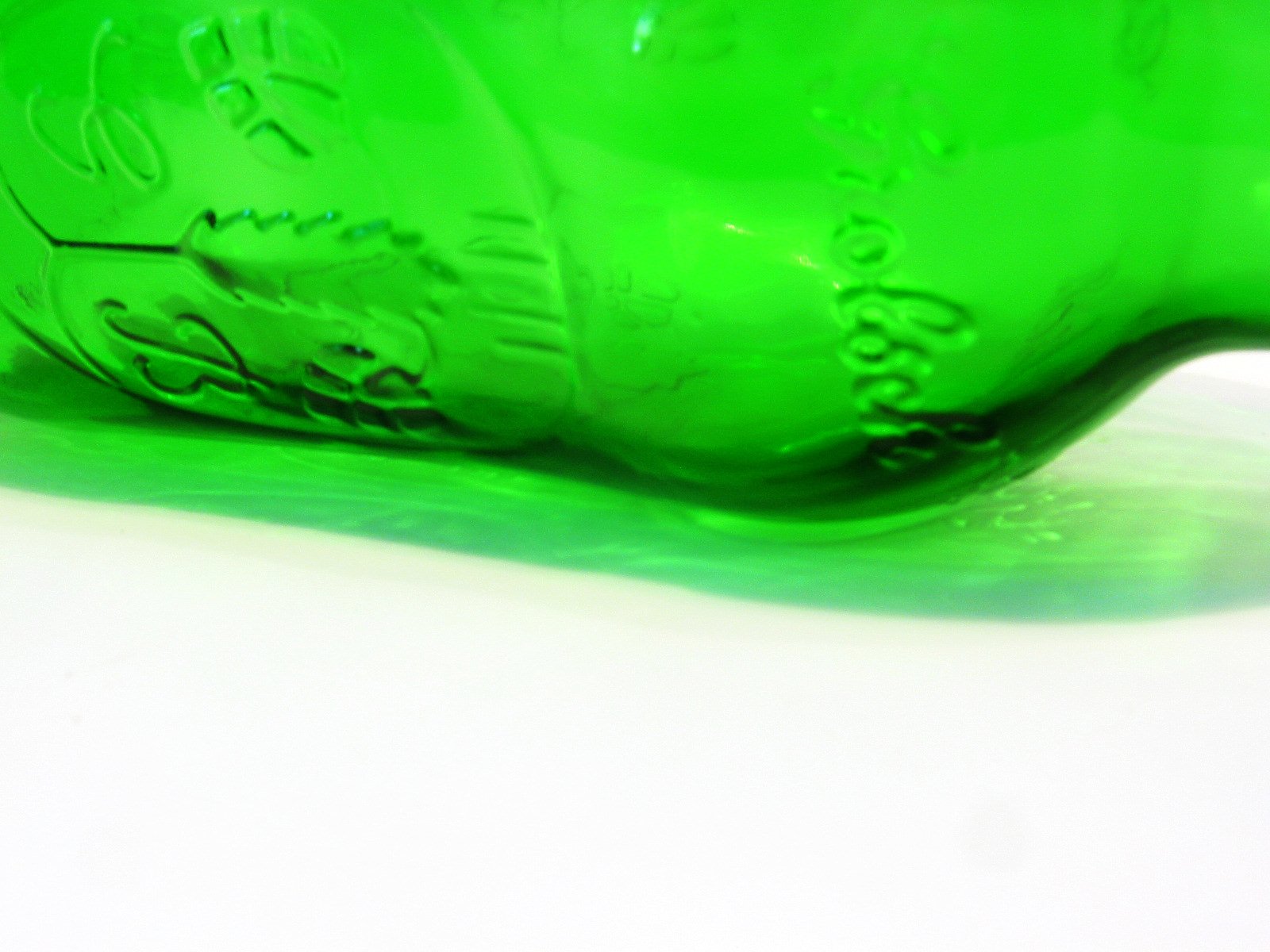 a green bottle that is sitting on the floor