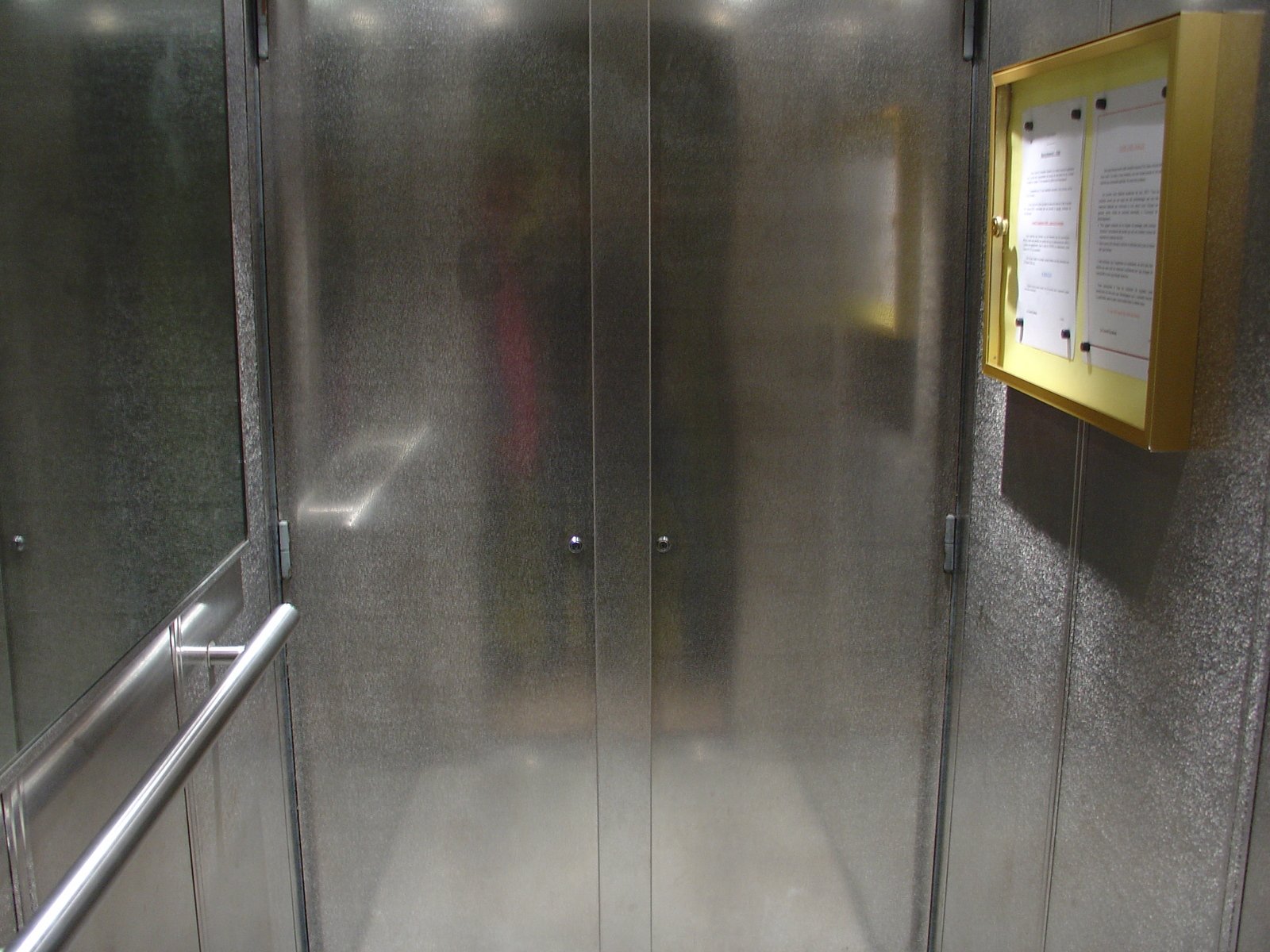 a shower with metal walls inside a bathroom