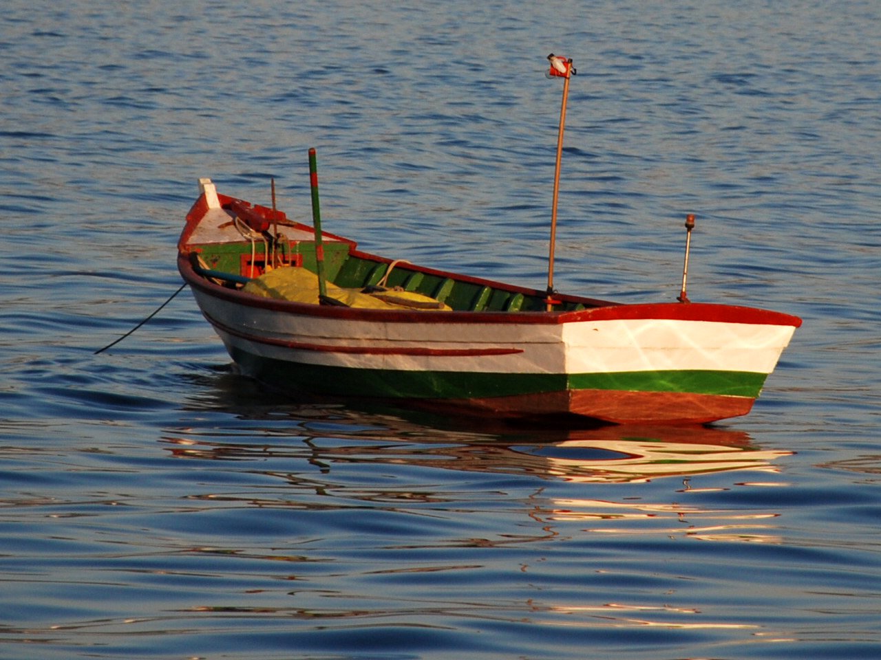 a boat in a body of water with a flag on it