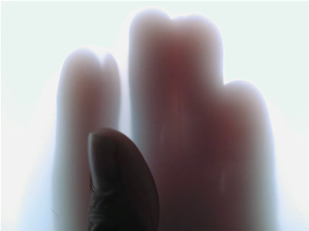 a blurry pograph of a finger with its thumb extended to the side