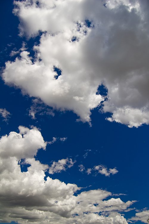 a large group of clouds and the sun peeking through