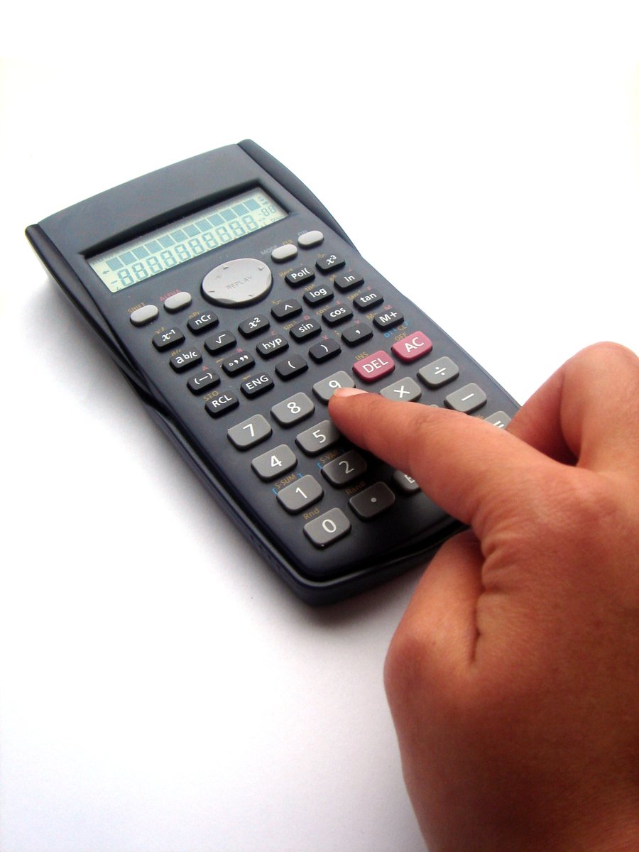 a hand using a calculator to record the numbers