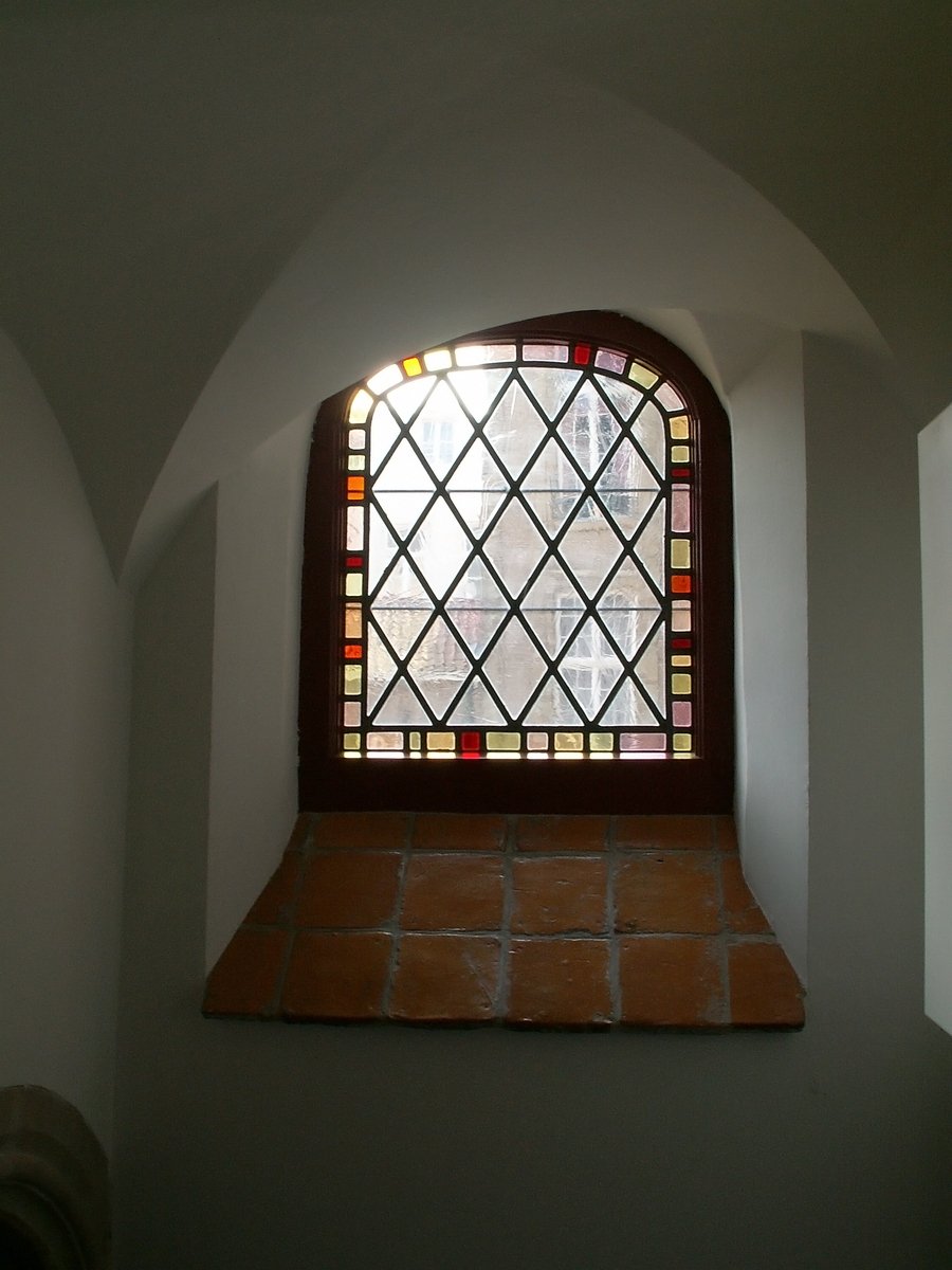 the sunlight shines through a stained glass window