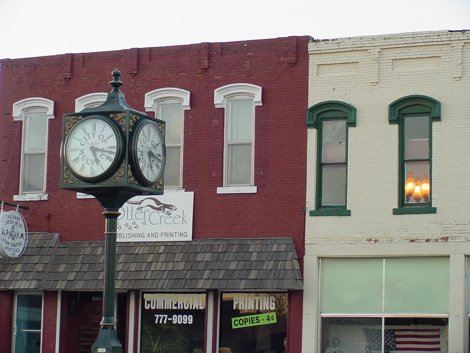 an old clock on a city street corner