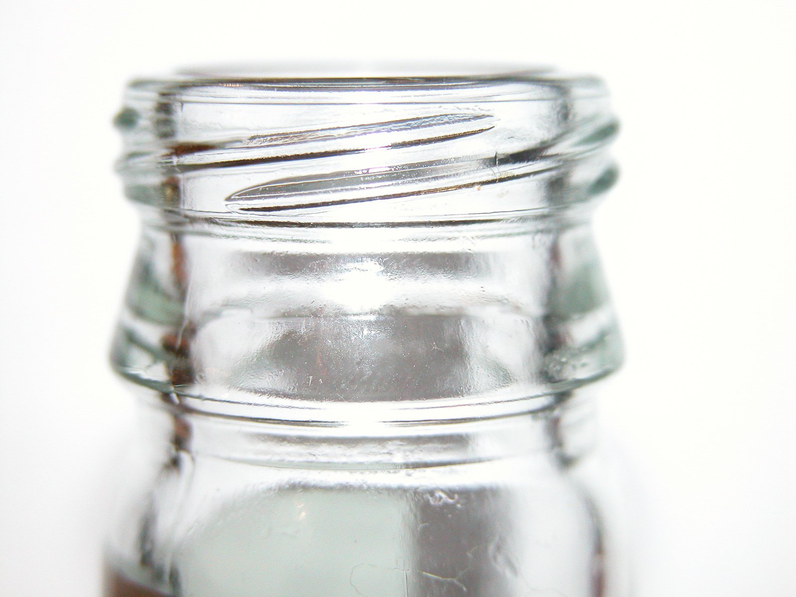 a close up of a glass jar with liquid