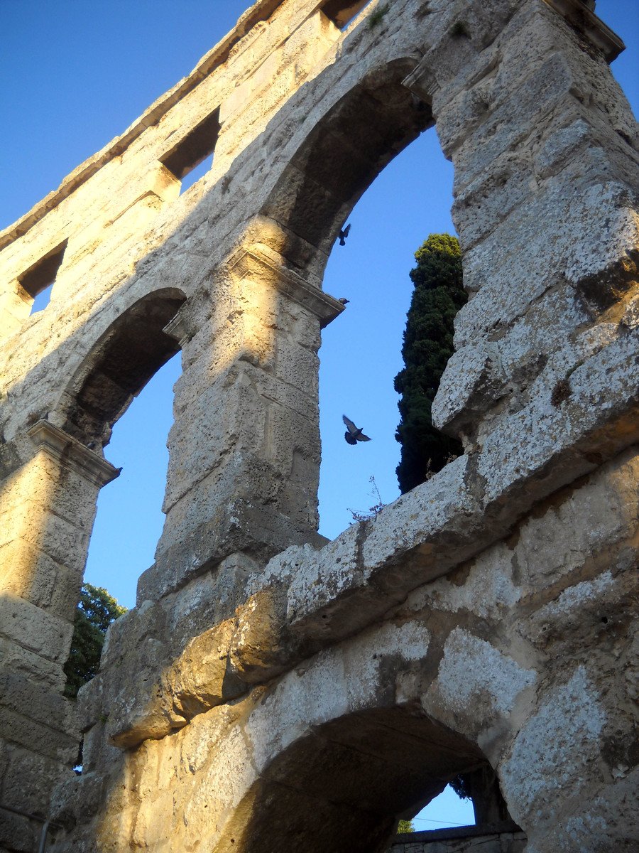 an old building with stone walls and arches