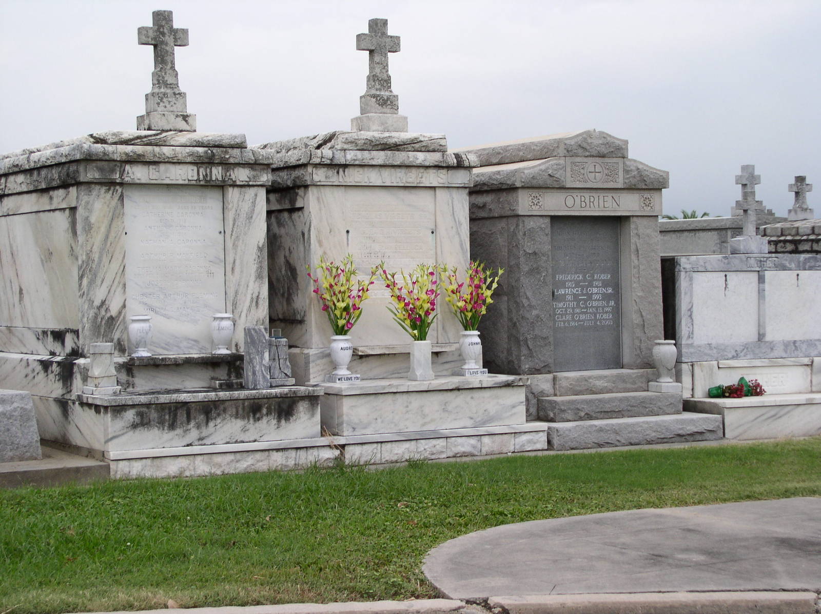 some flower pots are on the headstones of graves