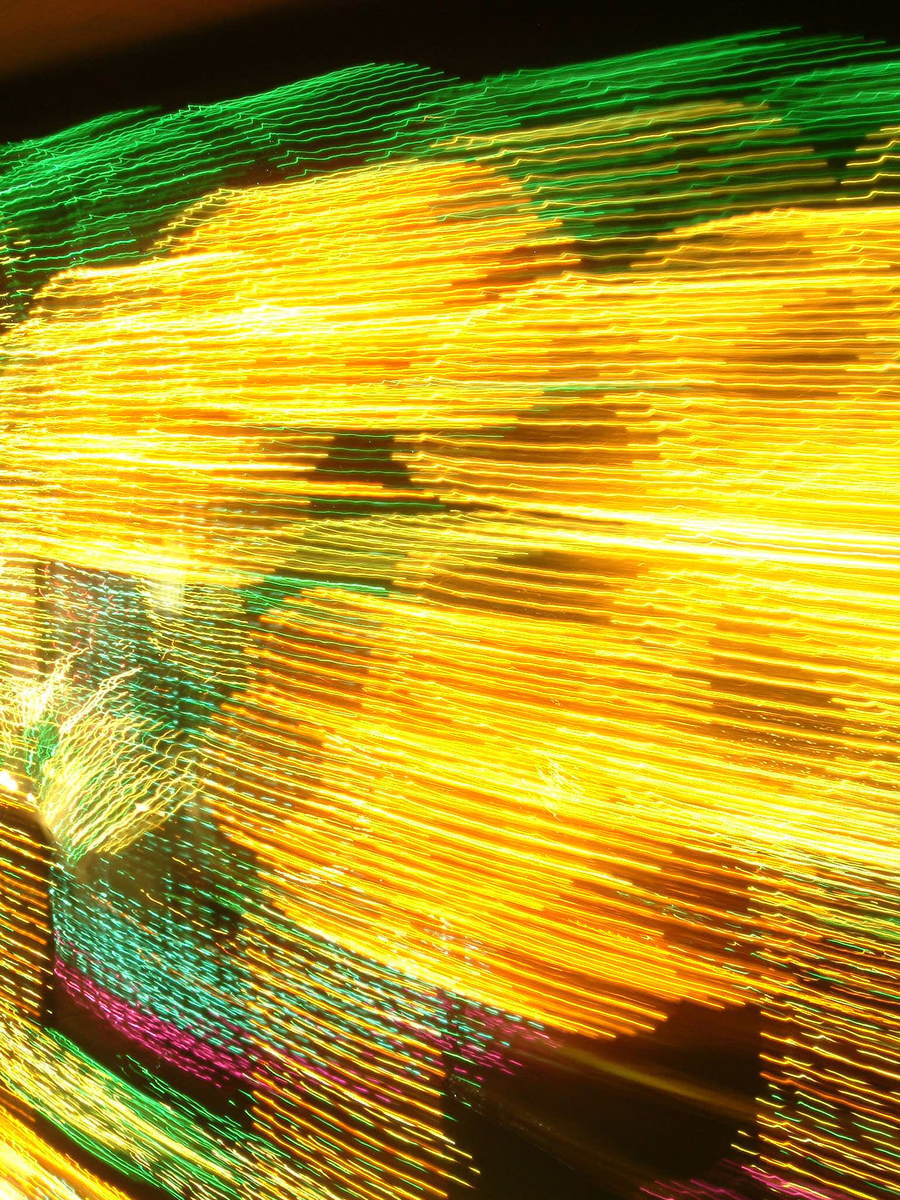 blurred s of a man wearing black shirt and jeans with a yellow shirt underneath him