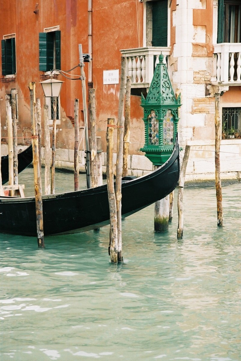 a gondola and a water hose with some green painted buildings