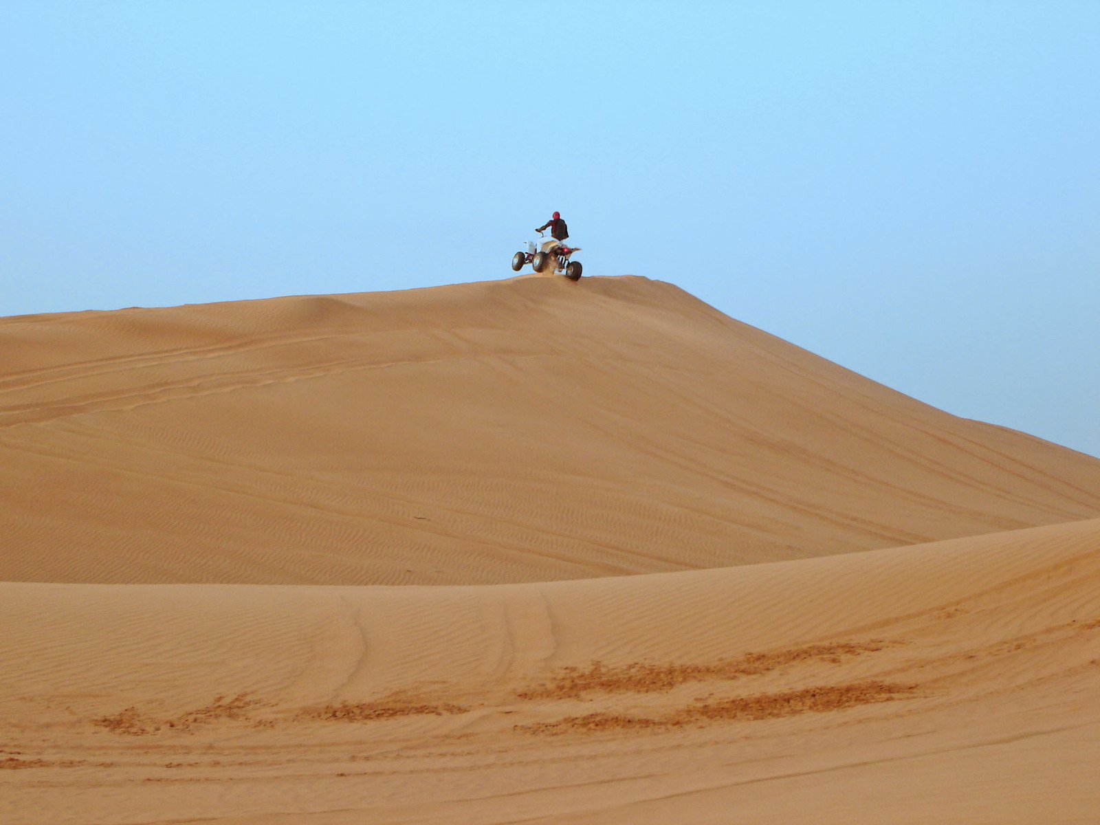 the lone rider is sitting on his motorcycle in the desert