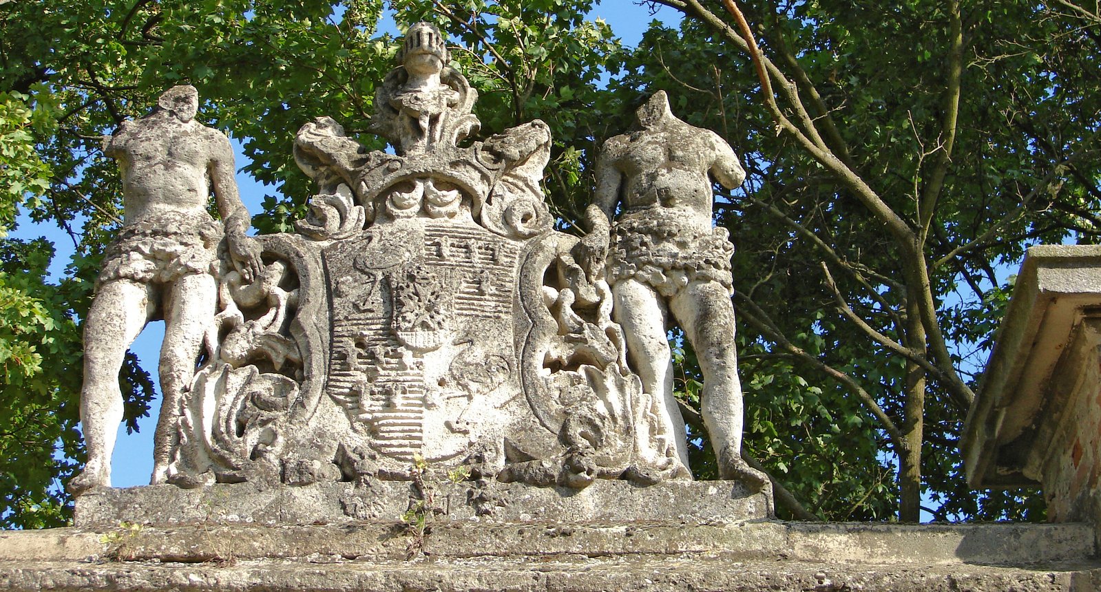 some statues are displayed in front of trees