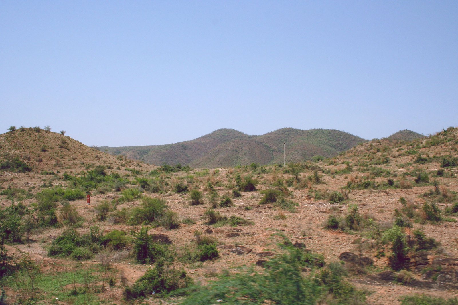the barren desert area with two mountain ranges in the distance