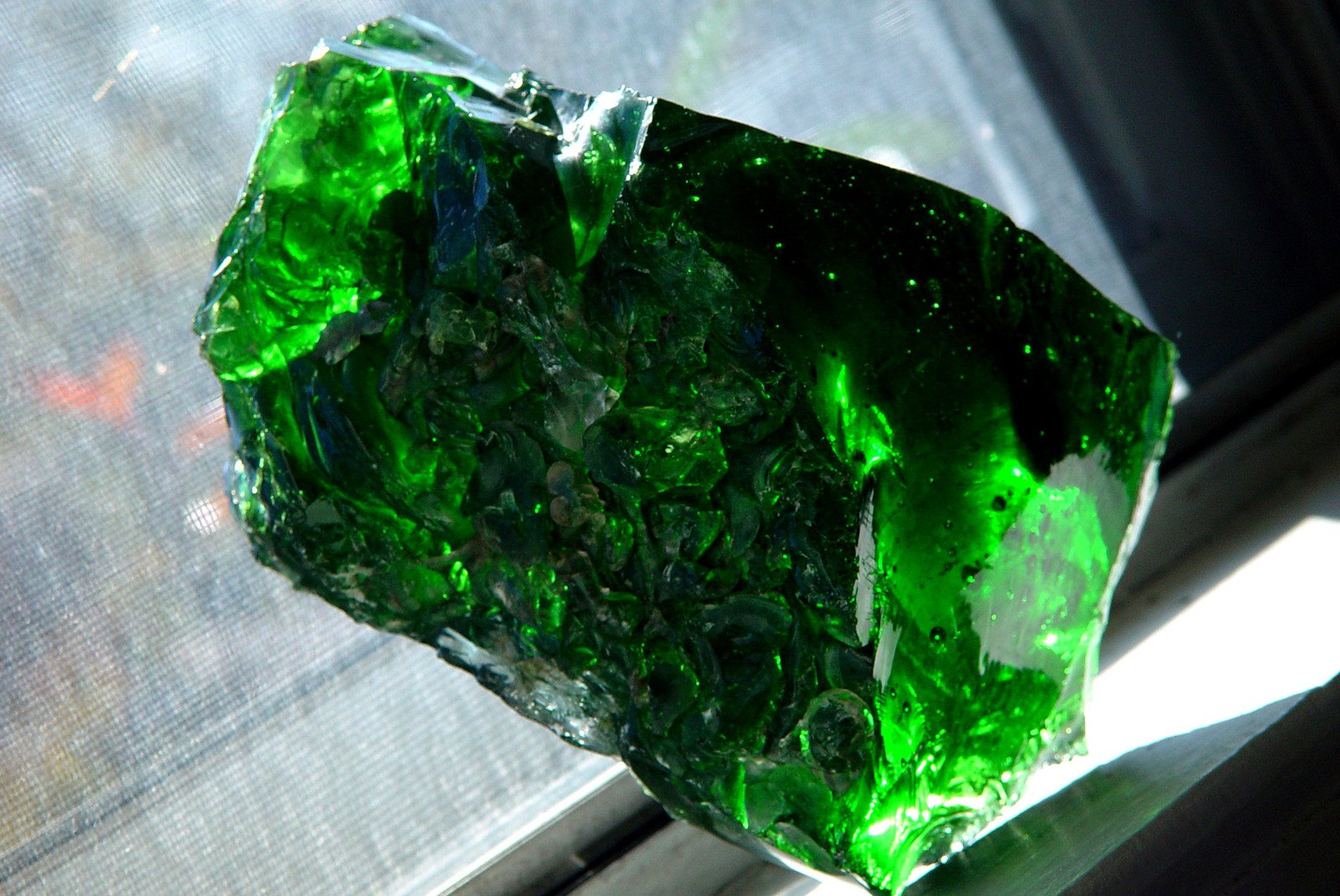 some very big green crystals that are on a window sill