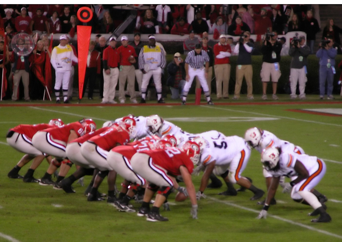 a group of football players in line on the field