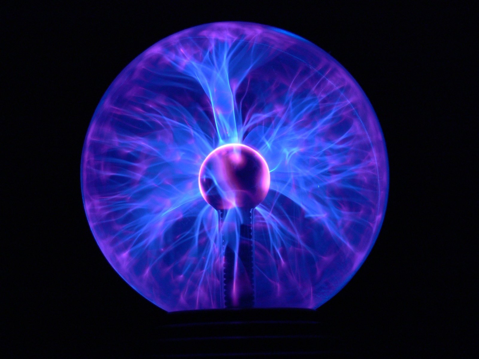 a circular purple object lit up at night