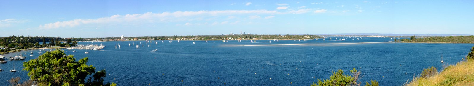 a large blue lake with many sail boats on it