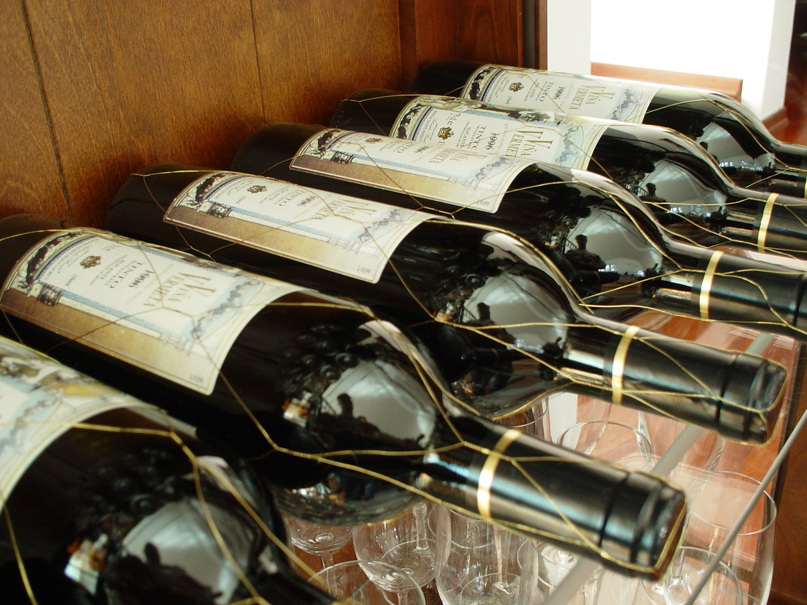 several bottles and glasses of wine on a table