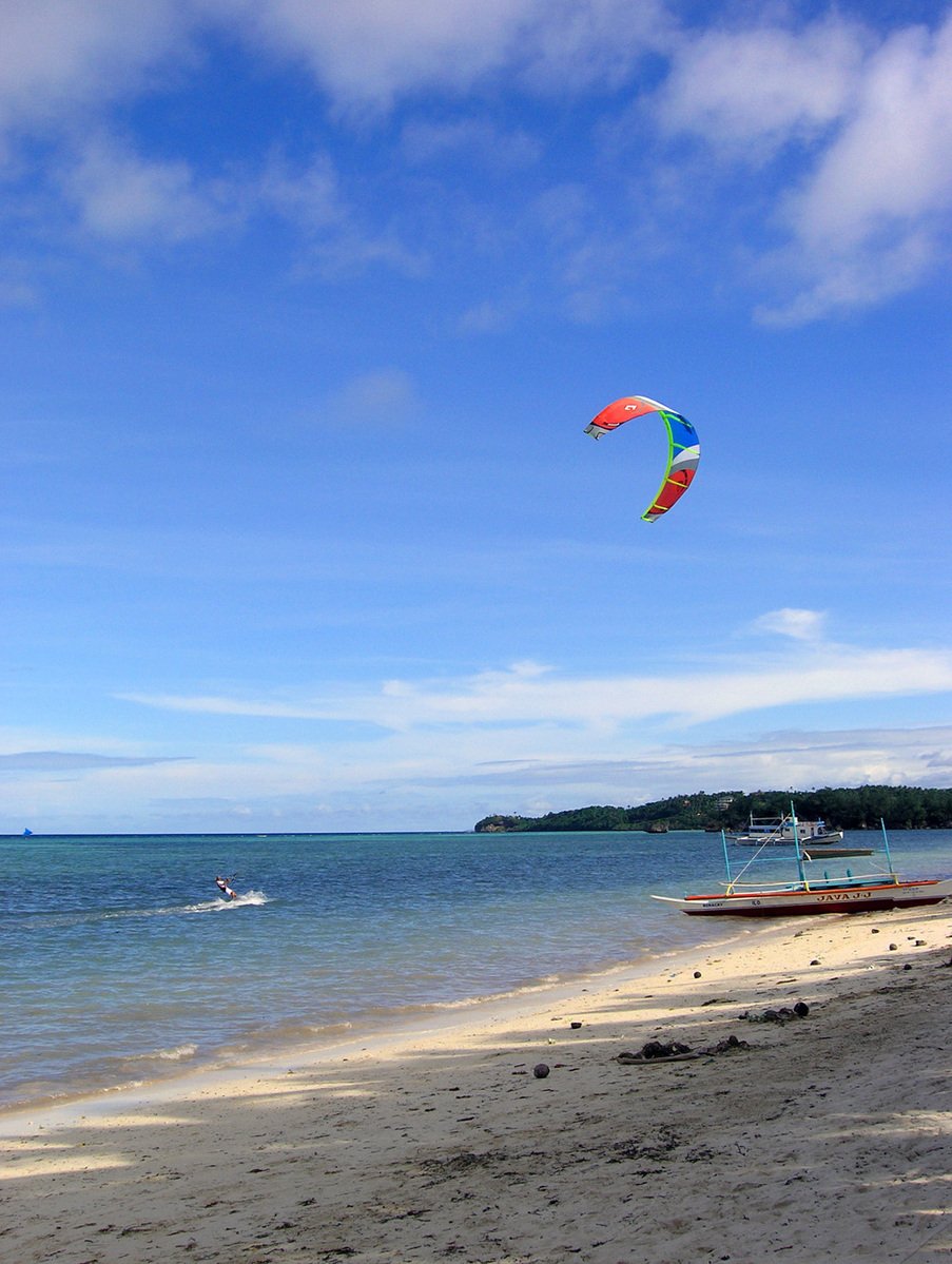 a man riding a kite board on top of the ocean