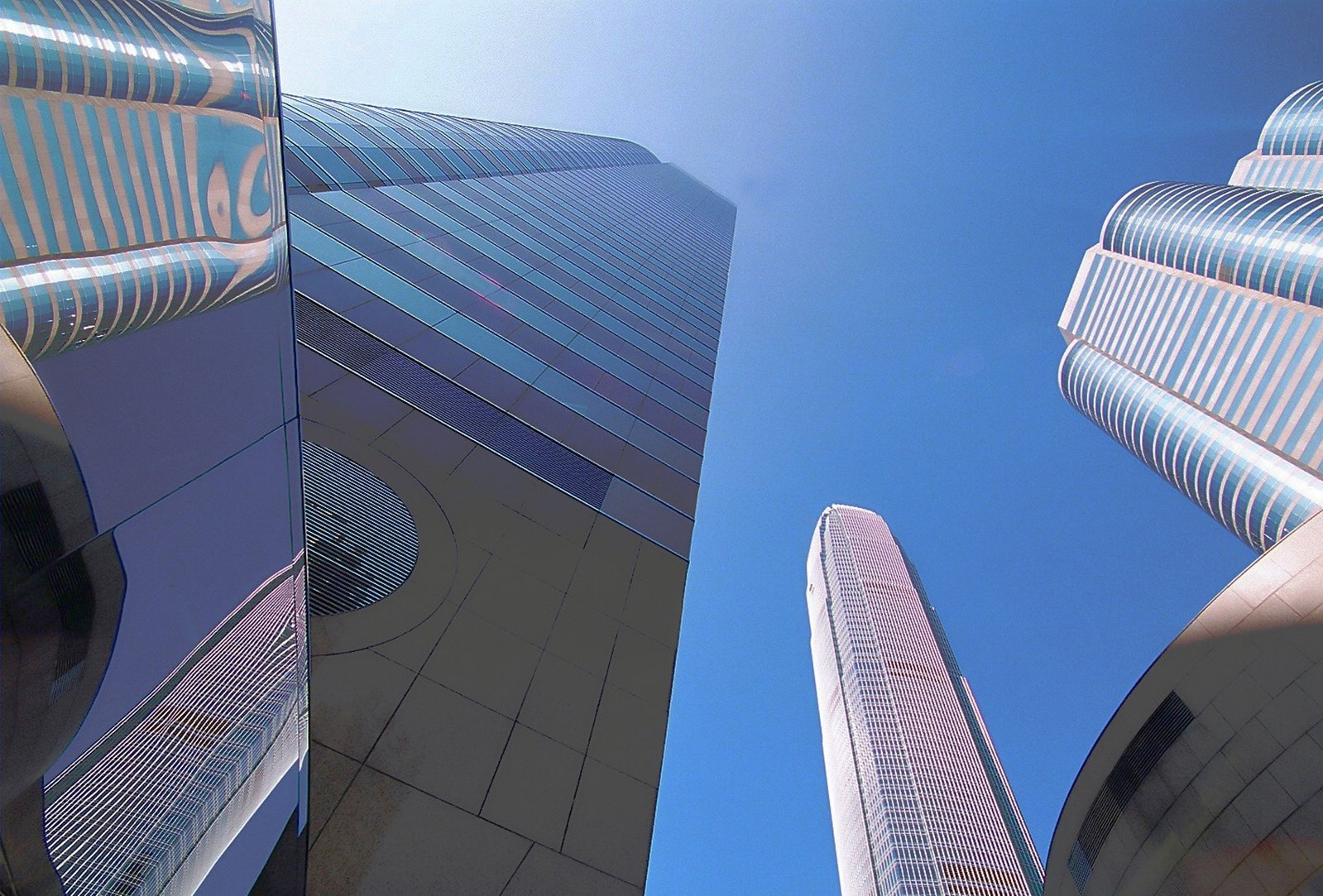 a close up view of two tall skyscrs against a blue sky