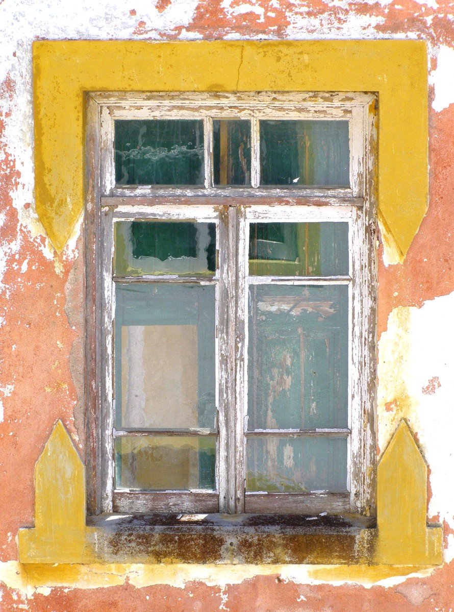 a yellow and white wall with some windows