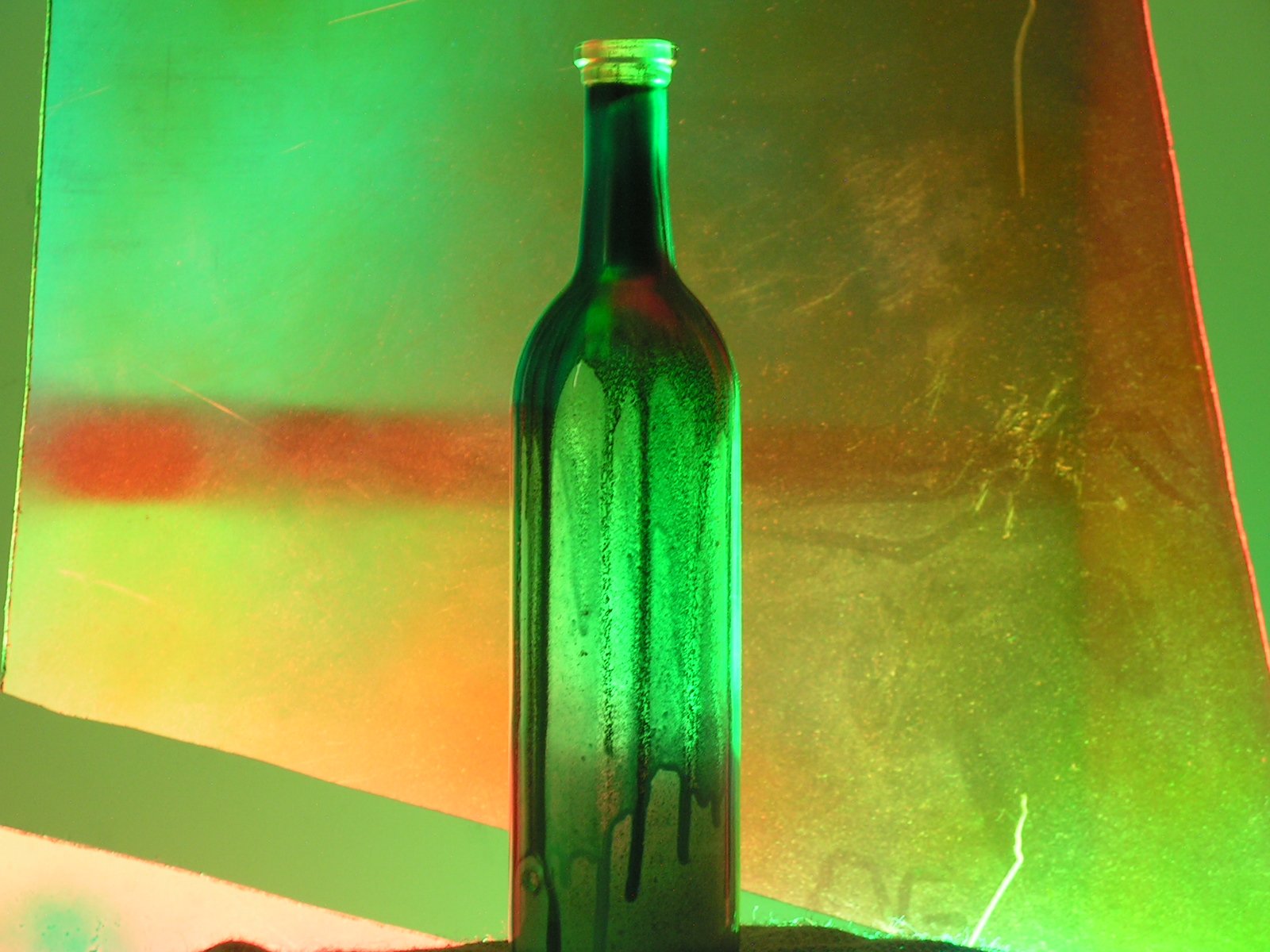 the bottle is glowing green while sitting on a table