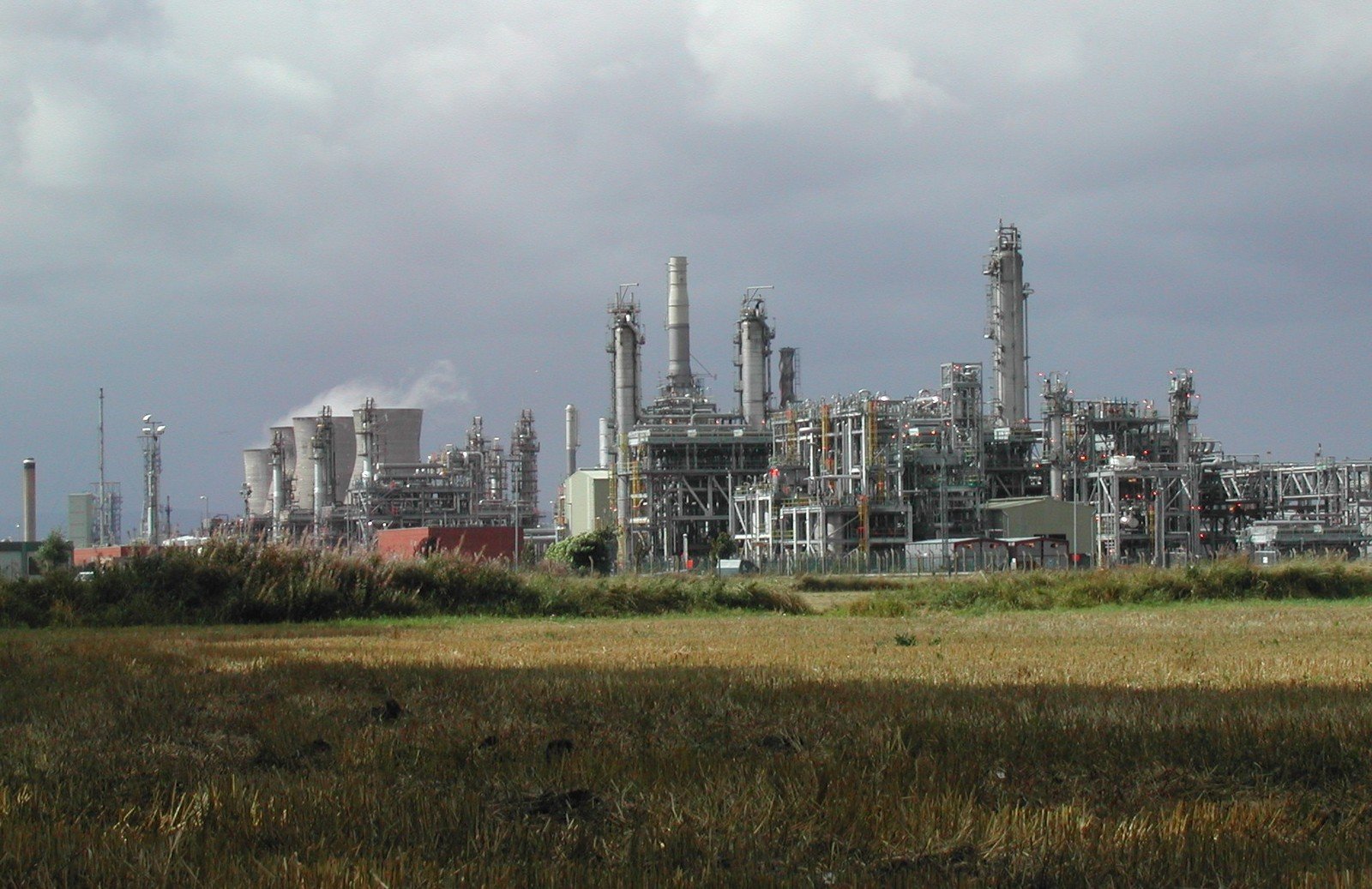 a large factory with smoke stacks is shown