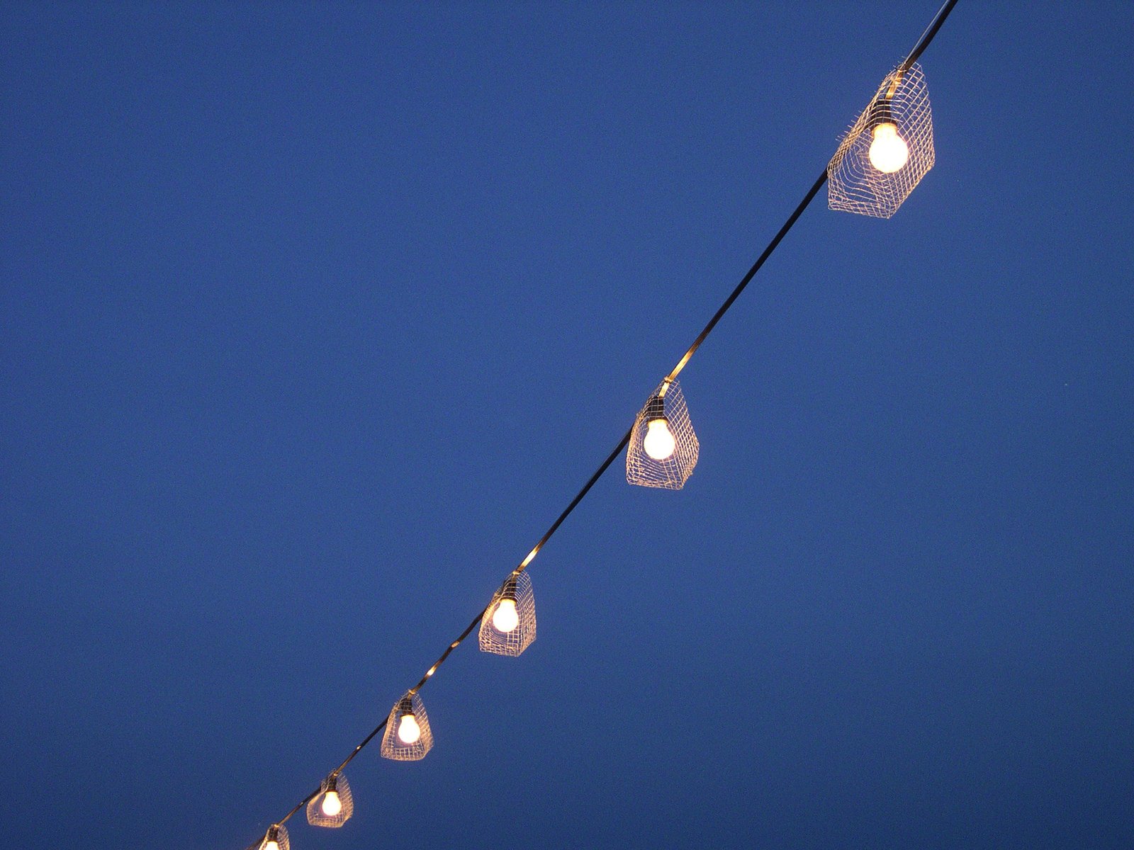 a line of string lights on an outdoor string
