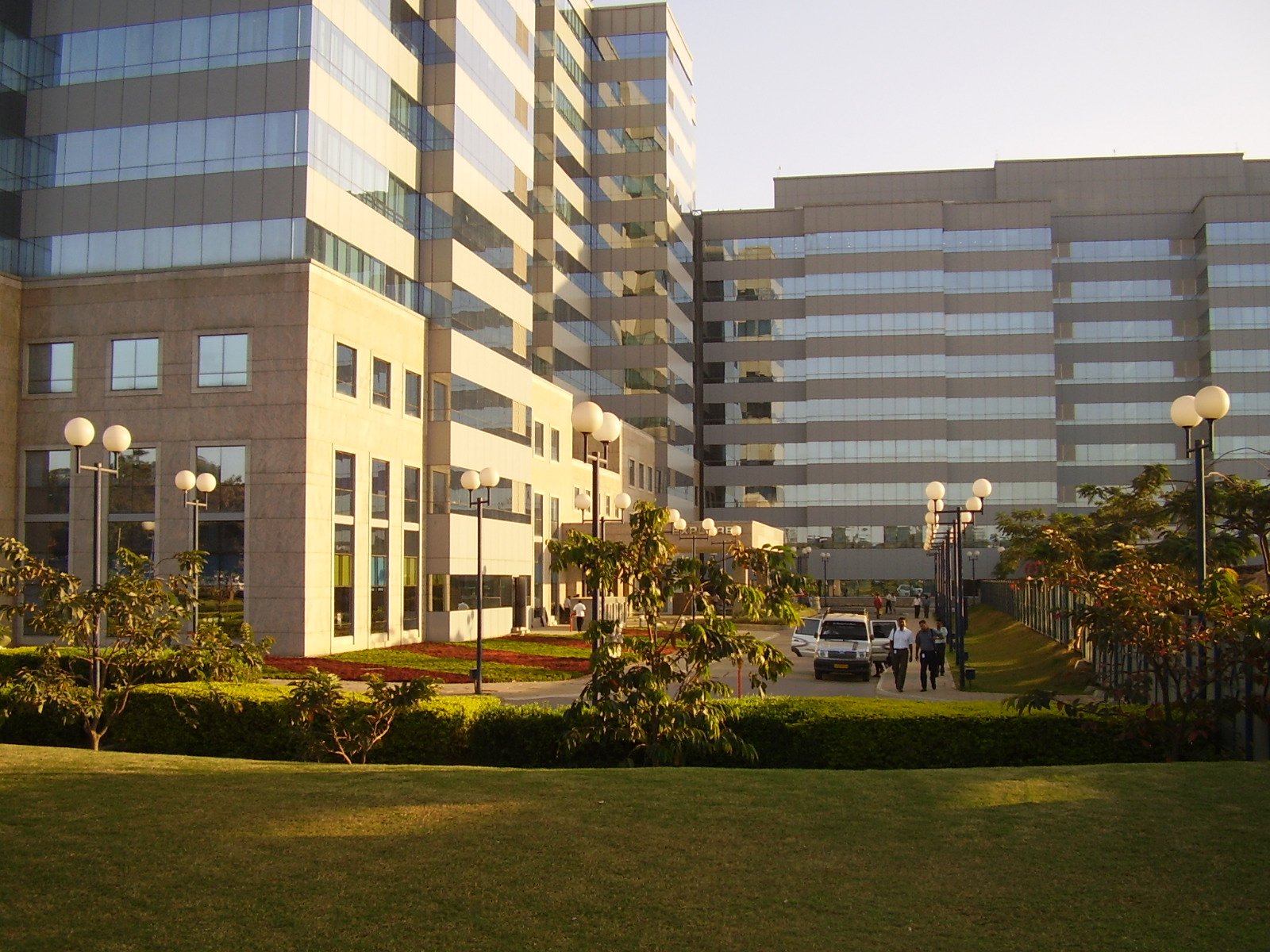 the two office buildings look very modern, yet the grass is greenery