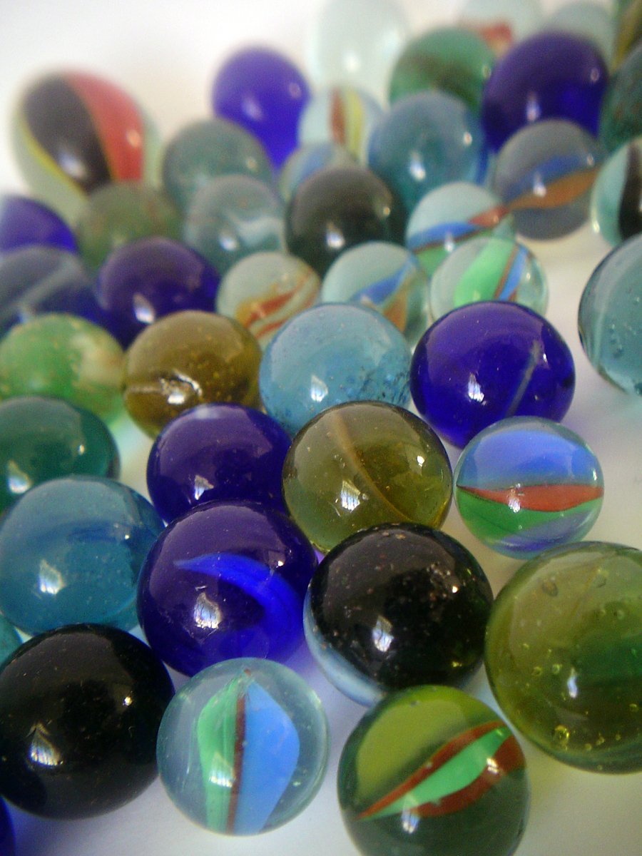 a mixture of glass marbles on top of a table