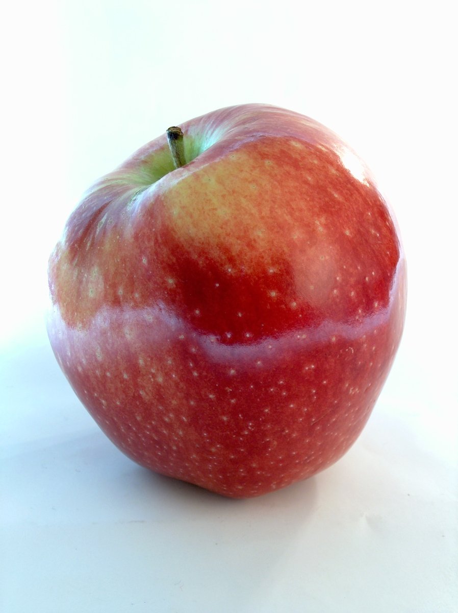 an apple with red and yellow stripes on the stem