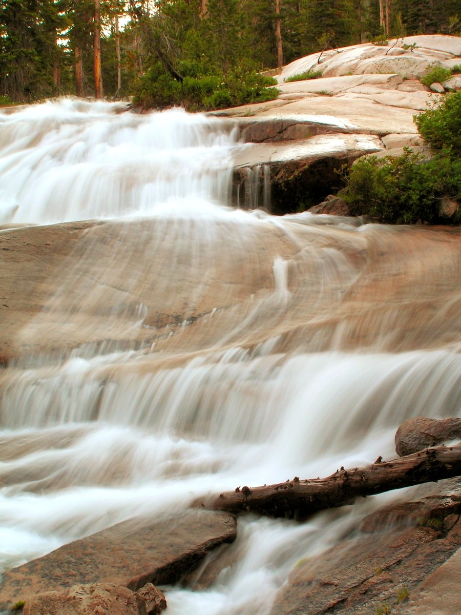 a beautiful waterfall coming out of the woods