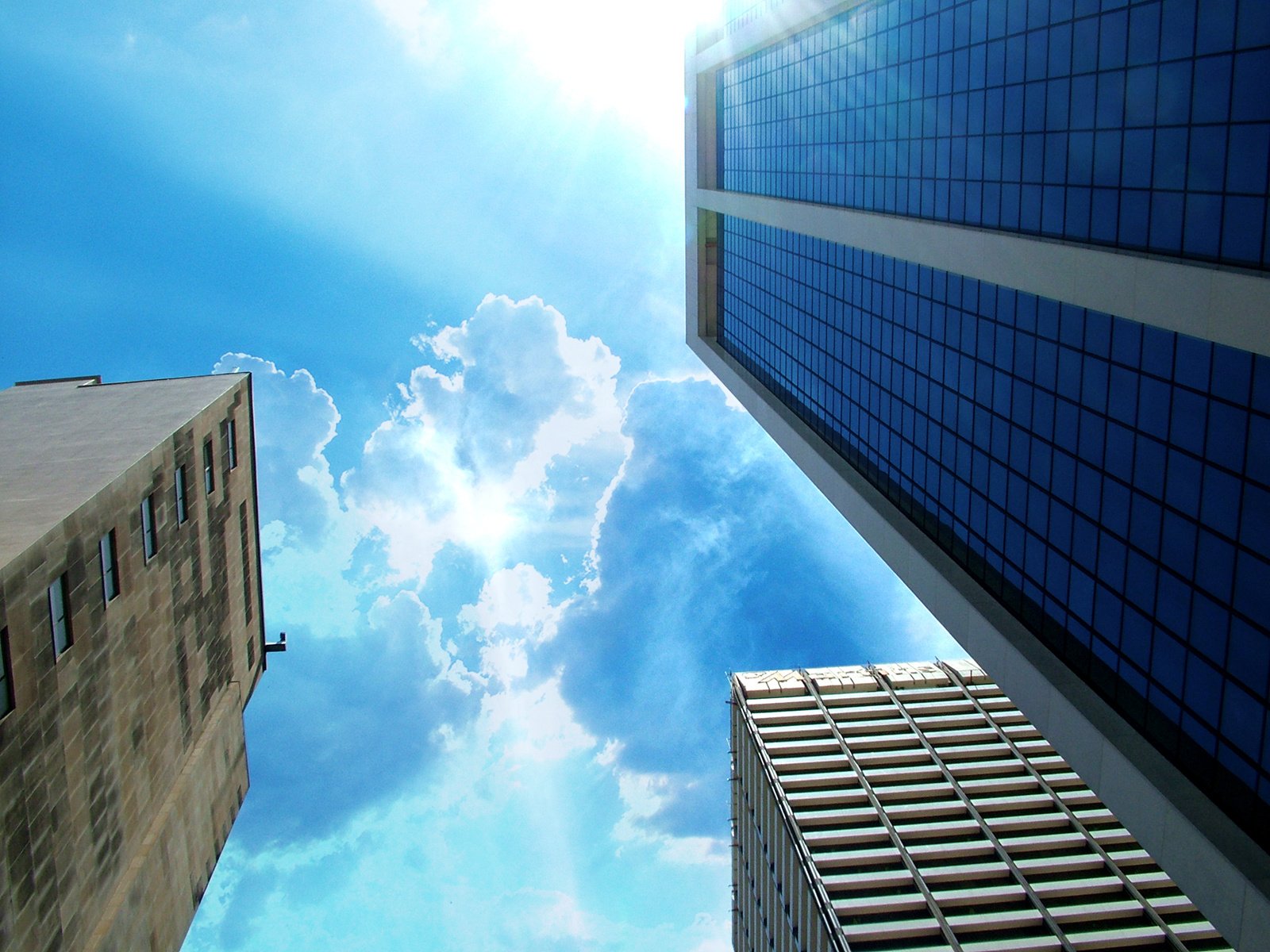 two tall buildings with windows and a sky background