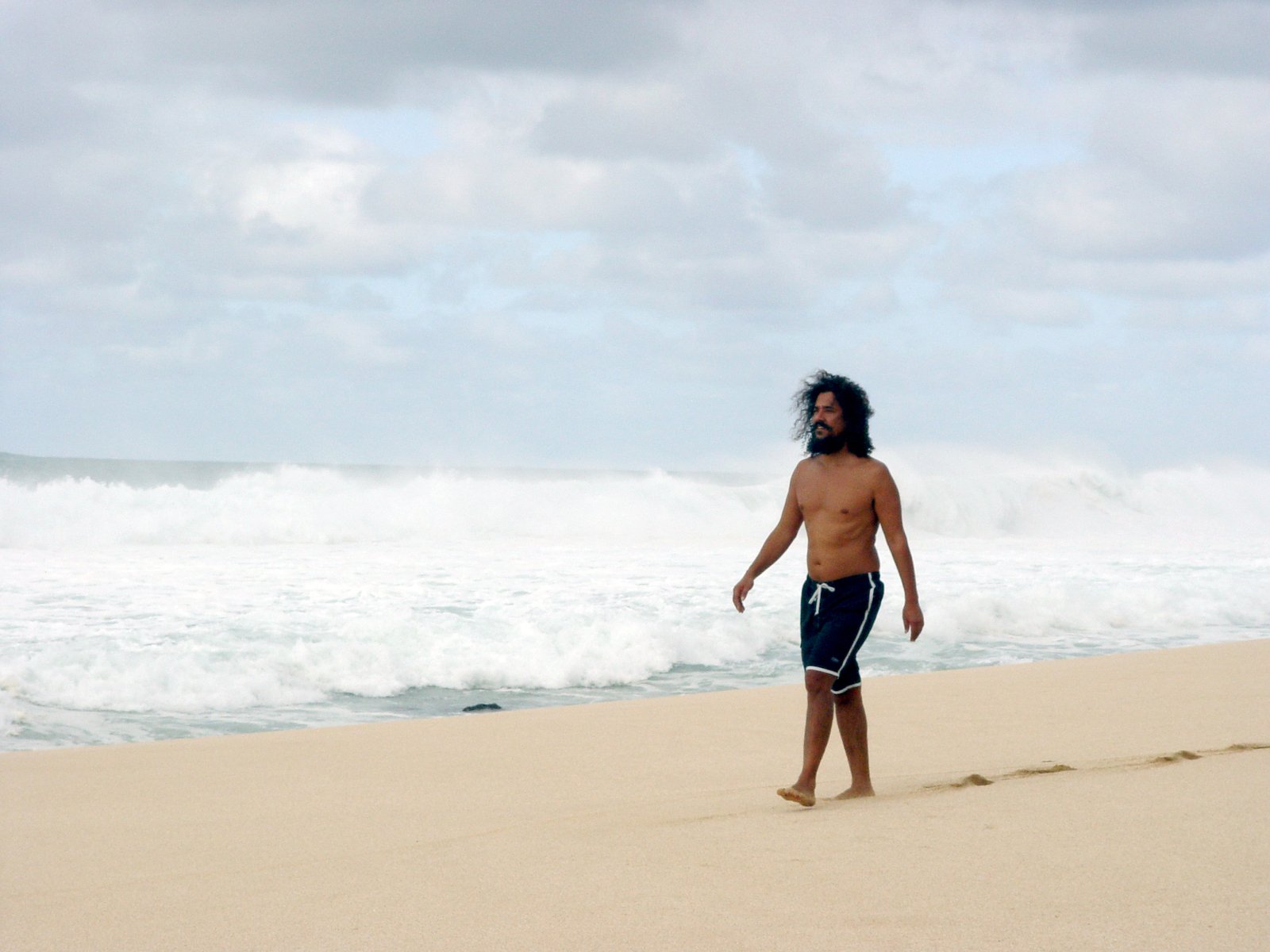 a man standing on top of a sandy beach