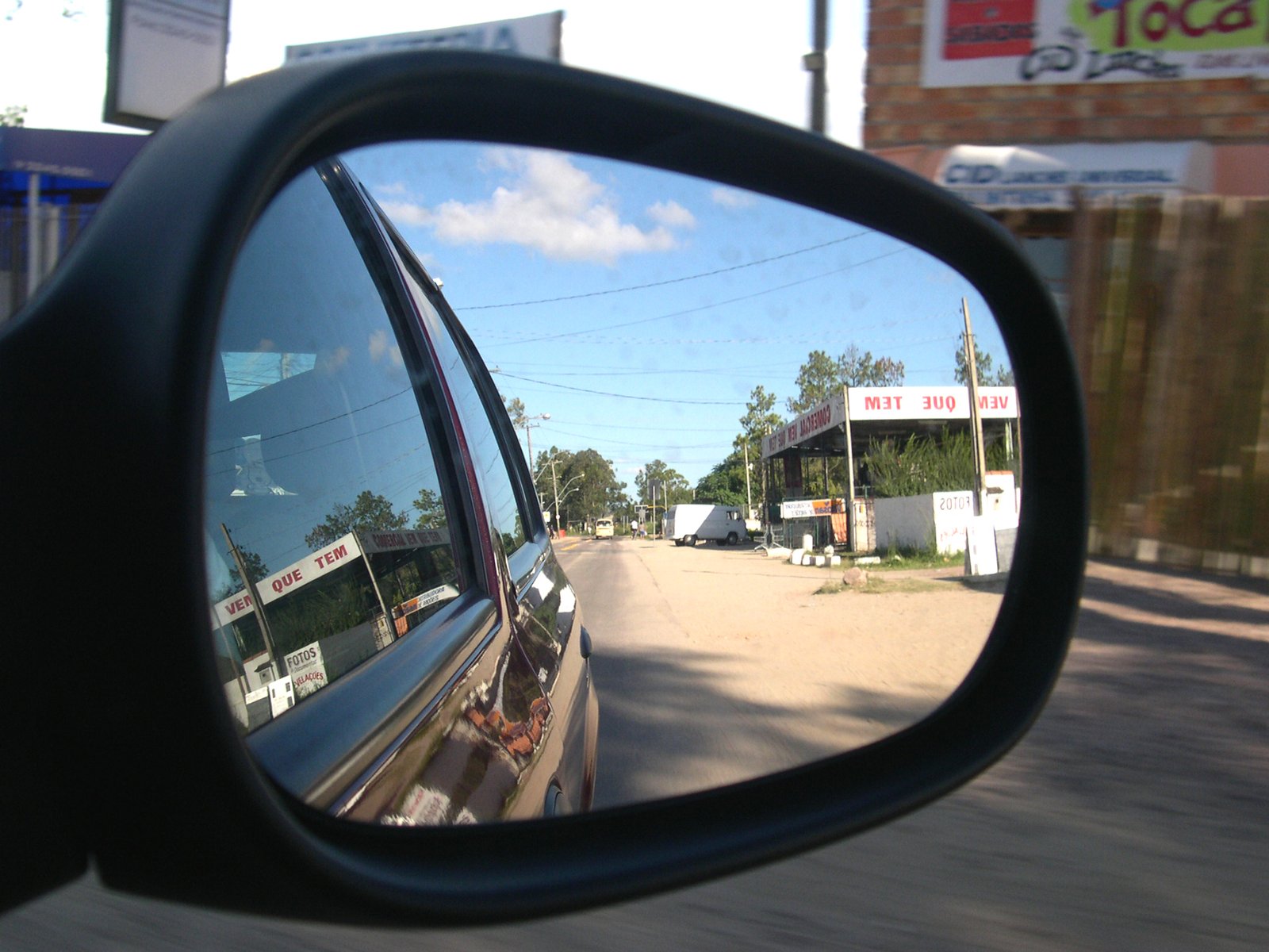 a reflection of the side mirror in the rear view mirror