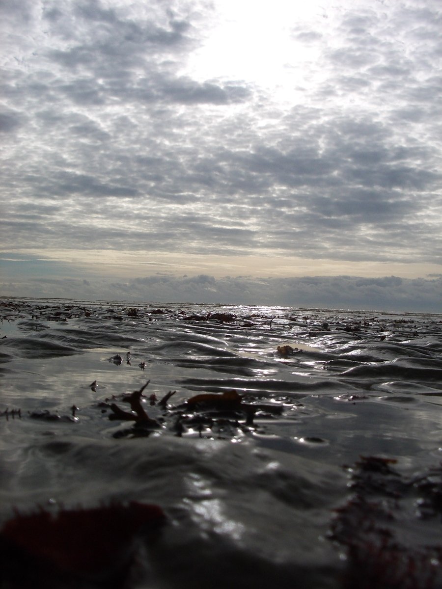 a beach area with many waves in the water