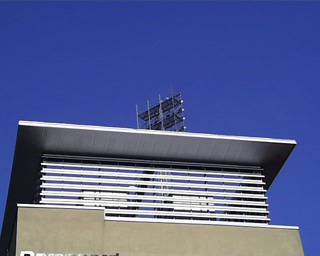 a sky is seen behind the top of a building